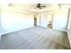 Primary bedroom featuring plush carpeting, a ceiling fan, and doorways to the bathroom and walk-in closet at 356 Bishop Ln, Sanford, NC 27330