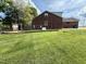 Lush backyard with a well-maintained lawn, a generator, and room for outdoor activities at 3605 Mine Creek Rd, Burlington, NC 27217