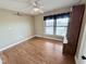Sunny bedroom with hardwood floors, nice window with blinds, and a decorative hutch at 3605 Mine Creek Rd, Burlington, NC 27217