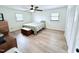 Bright bedroom with two windows, a ceiling fan and a traditional wood storage chest at the foot of the bed at 3605 Mine Creek Rd, Burlington, NC 27217