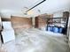 Functional garage with storage shelves, brick, utility connections, and ample space for parking and projects at 3605 Mine Creek Rd, Burlington, NC 27217
