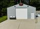 Spacious detached garage with a large roll-up door and a side entrance at 3605 Mine Creek Rd, Burlington, NC 27217