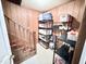 Hallway staircase with shelving, offering ample storage solutions, and convenient access to upper levels at 3605 Mine Creek Rd, Burlington, NC 27217