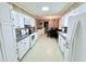 Well-lit kitchen with white cabinets, modern appliances, and an adjoining dining area at 3605 Mine Creek Rd, Burlington, NC 27217