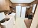 Functional laundry room featuring wood cabinets, washer, dryer, storage options, and neutral flooring at 3605 Mine Creek Rd, Burlington, NC 27217
