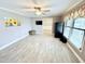 Bright living room with light wood floors, ceiling fan, and cheerful sunflower art at 3605 Mine Creek Rd, Burlington, NC 27217