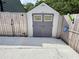 Storage shed with double doors and a decorative window, ideal for garden supplies at 3605 Mine Creek Rd, Burlington, NC 27217
