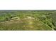 Panoramic aerial shot showcasing a home surrounded by trees and farmland at 435 Salt And Light Ln, Henderson, NC 27537