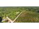 Expansive aerial view featuring a rural property surrounded by trees and fields at 435 Salt And Light Ln, Henderson, NC 27537