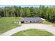 Aerial view of a cozy home, with a spacious yard, a porch, and surrounded by lush greenery at 435 Salt And Light Ln, Henderson, NC 27537