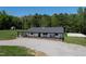 Scenic aerial view of a home with a large yard, shed, basketball court, and lush greenery at 435 Salt And Light Ln, Henderson, NC 27537