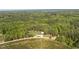 Stunning aerial view of a property nestled among lush trees and farmland at 435 Salt And Light Ln, Henderson, NC 27537