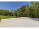 A well-maintained basketball court surrounded by lush greenery and mature trees at 435 Salt And Light Ln, Henderson, NC 27537
