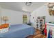Bright bedroom featuring wood floors, a blue quilted bed, and a window overlooking the outdoor scenery at 435 Salt And Light Ln, Henderson, NC 27537