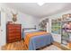 Bedroom featuring a large window, hardwood floors, and a cozy bed with wood dresser at 435 Salt And Light Ln, Henderson, NC 27537
