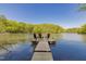 Charming private wooden dock with seating offers a tranquil lakeside experience with scenic views at 435 Salt And Light Ln, Henderson, NC 27537