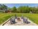 Outdoor area with a fire pit surrounded by chairs, perfect for relaxing and enjoying the natural surroundings at 435 Salt And Light Ln, Henderson, NC 27537