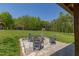 Beautiful outdoor firepit area with chairs arranged for gatherings, set against a green lawn and wooded backdrop at 435 Salt And Light Ln, Henderson, NC 27537