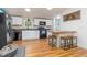Open kitchen design with white cabinets, custom wood breakfast bar and black appliances at 435 Salt And Light Ln, Henderson, NC 27537
