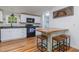Kitchen features white cabinets, modern appliances, and a custom wooden breakfast bar at 435 Salt And Light Ln, Henderson, NC 27537