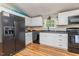 Spacious kitchen with black appliances, ample counter space, and white cabinets at 435 Salt And Light Ln, Henderson, NC 27537