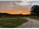 Scenic landscape featuring a vibrant sunset sky and lush green meadows at 435 Salt And Light Ln, Henderson, NC 27537