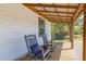 Cozy porch featuring rocking chairs and outdoor lighting, creating a relaxing and inviting space at 435 Salt And Light Ln, Henderson, NC 27537