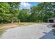 Expansive backyard features a gravel driveway, playset, and detached garage at 4467 Virgilina Rd, Roxboro, NC 27574