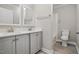 Bathroom features a double vanity with granite countertop and luxury vinyl plank flooring at 4467 Virgilina Rd, Roxboro, NC 27574