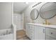 Bathroom features a double vanity, modern light fixtures, and walk-in shower at 4467 Virgilina Rd, Roxboro, NC 27574