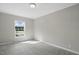 Cozy bedroom featuring a large window for ample natural light and neutral gray carpet at 4467 Virgilina Rd, Roxboro, NC 27574