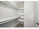 Walk-in closet features built-in shelving, and carpet flooring at 4467 Virgilina Rd, Roxboro, NC 27574
