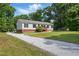 Front exterior featuring a gravel driveway and a cozy single-story home with a welcoming porch at 4467 Virgilina Rd, Roxboro, NC 27574