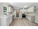Well-lit kitchen featuring white cabinets, modern appliances, and sleek countertops, providing a functional space at 4467 Virgilina Rd, Roxboro, NC 27574