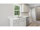 Bright kitchen features stainless steel appliances, white cabinets, and a large window over the sink at 4467 Virgilina Rd, Roxboro, NC 27574