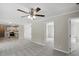 Open-concept living room showcasing a kitchen with modern appliances, a ceiling fan, and grey carpet at 4467 Virgilina Rd, Roxboro, NC 27574