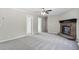 Open-concept living room with neutral carpet, fireplace, and ample natural light at 4467 Virgilina Rd, Roxboro, NC 27574