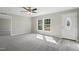 Open living room with carpet, natural light from the windows and view to the front door at 4467 Virgilina Rd, Roxboro, NC 27574