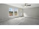 Bright living room with two large windows, neutral walls, carpet and a front door at 4467 Virgilina Rd, Roxboro, NC 27574