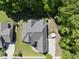 Aerial view of home with large lawn and surrounding trees at 5009 Coe Hill Pl, Cary, NC 27519