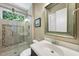 Bathroom featuring tile shower, glass door, and vanity at 5009 Coe Hill Pl, Cary, NC 27519