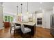 Gourmet kitchen with a large island, white cabinets, and stainless steel appliances at 5009 Coe Hill Pl, Cary, NC 27519