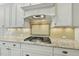 Well-appointed kitchen with stainless steel gas range and granite countertops at 5009 Coe Hill Pl, Cary, NC 27519
