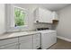 Functional laundry room with sink, counter space, and modern appliances at 5009 Coe Hill Pl, Cary, NC 27519