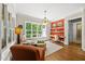 Bright living room with large windows, hardwood floors, and a built-in desk area at 5009 Coe Hill Pl, Cary, NC 27519