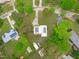 Aerial view of a home with solar panels on the roof, surrounded by lush greenery in a residential area at 5144 Jeffries St, Raleigh, NC 27606