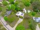 Aerial view of a home with solar panels on the roof, surrounded by mature trees and well-kept lawns at 5144 Jeffries St, Raleigh, NC 27606