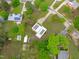 Aerial view of a home with solar panels, surrounded by lush greenery and a well-maintained lawn at 5144 Jeffries St, Raleigh, NC 27606