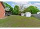 Expansive backyard featuring a patio, sheds, a swing, and plenty of green space for outdoor activities at 5144 Jeffries St, Raleigh, NC 27606