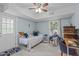 Sunlit bedroom features a bed, stylish furniture, and a large window with backyard views at 5144 Jeffries St, Raleigh, NC 27606
